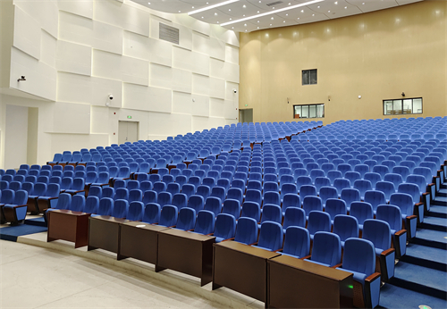 What is the purpose of the aisle reserved when installing auditorium chairs?