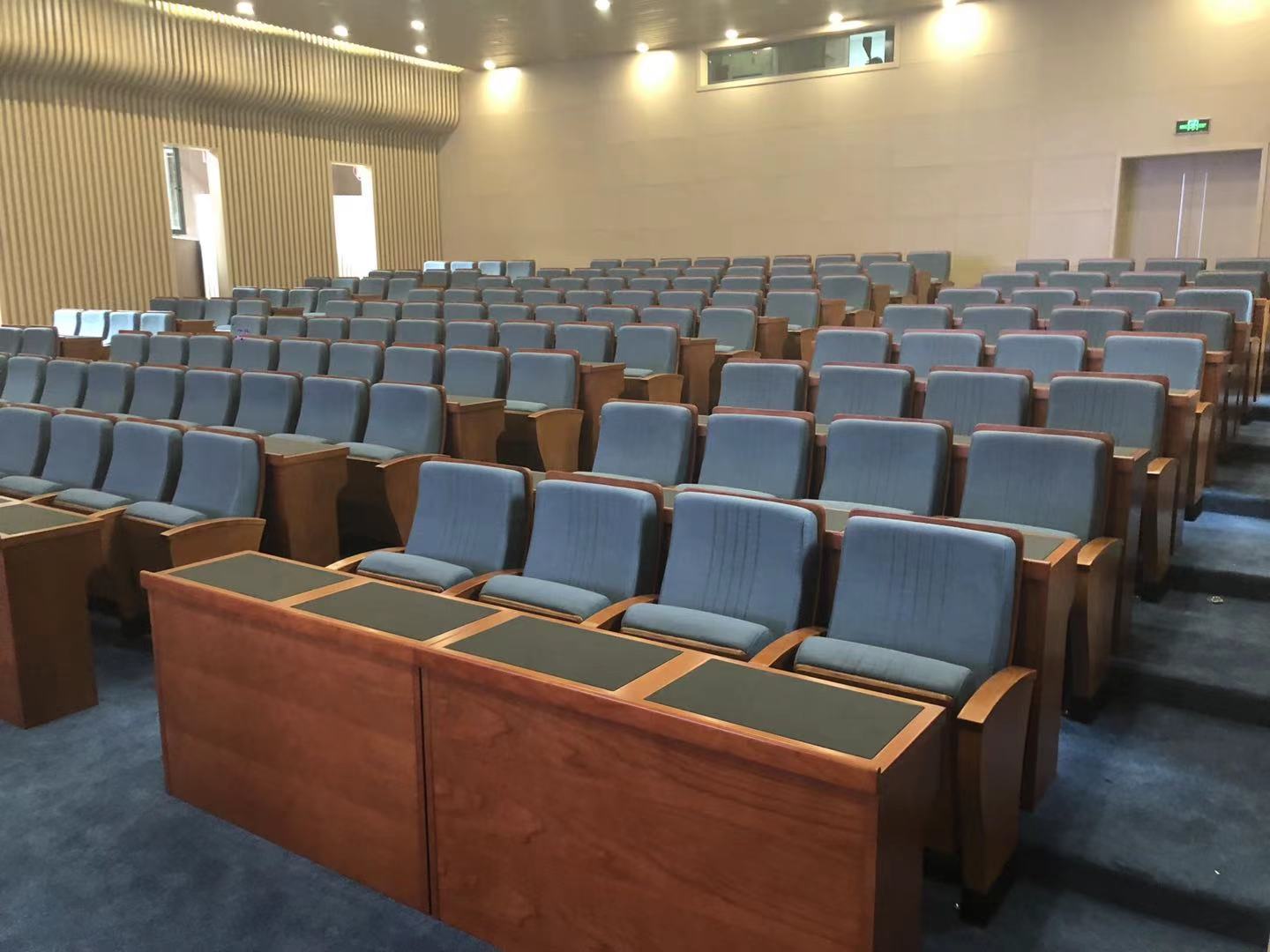 How do auditorium chairs apply ergonomics?