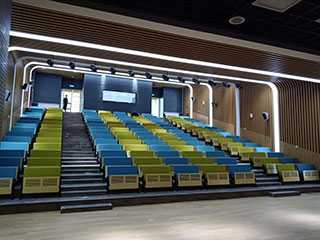 How is the school auditorium space divided according to auditorium seating?